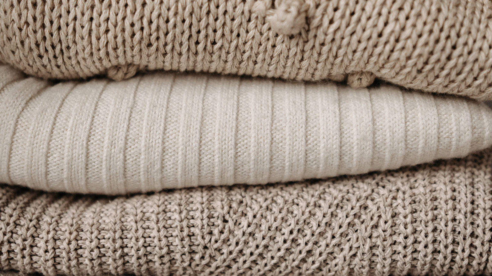 An image of a stack of woollen jumpers
