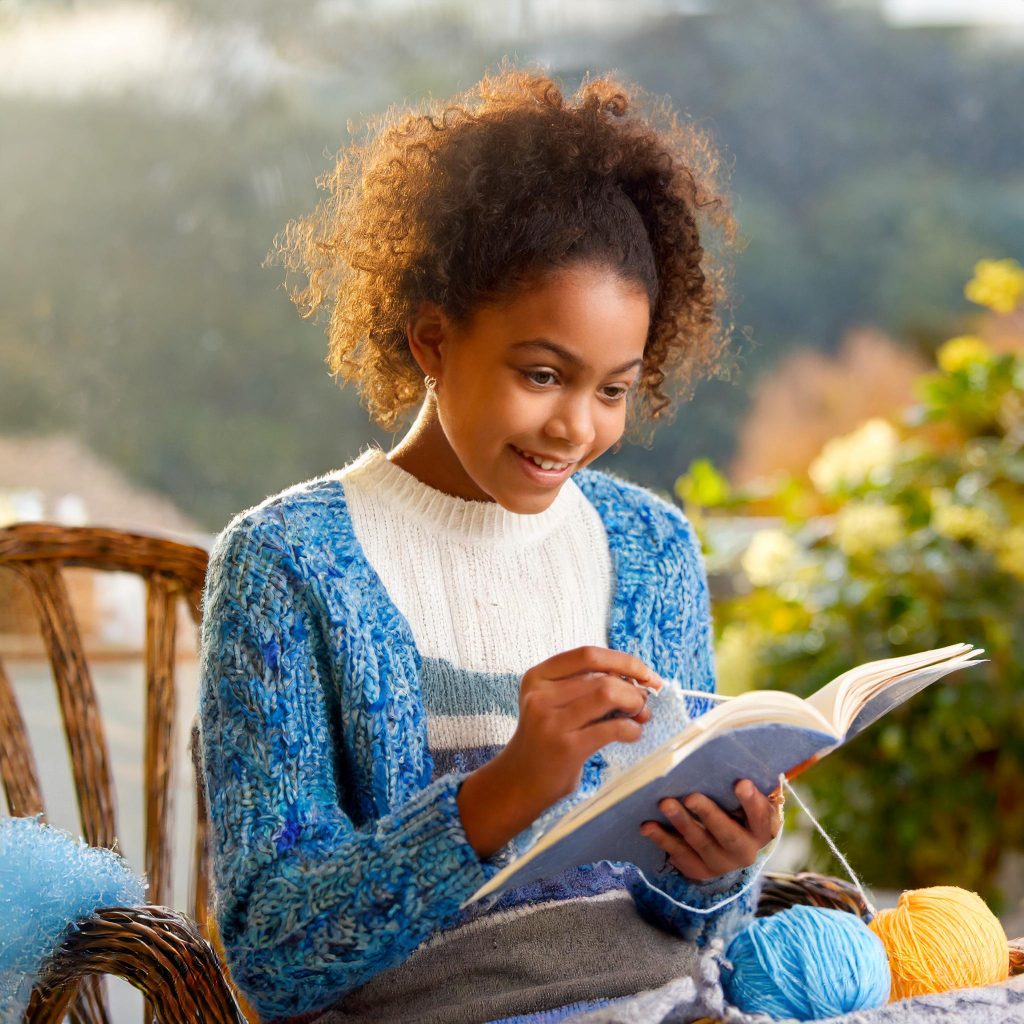 Firefly image of young person reading a knitting guide 59270